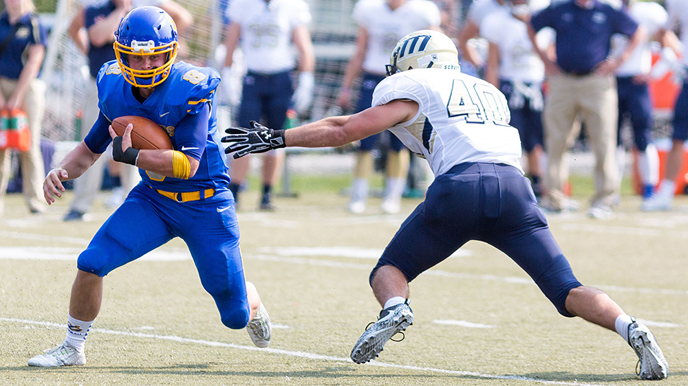 Corey Creeger running the ball, as Maine Maritime Academy quarterbacks do.