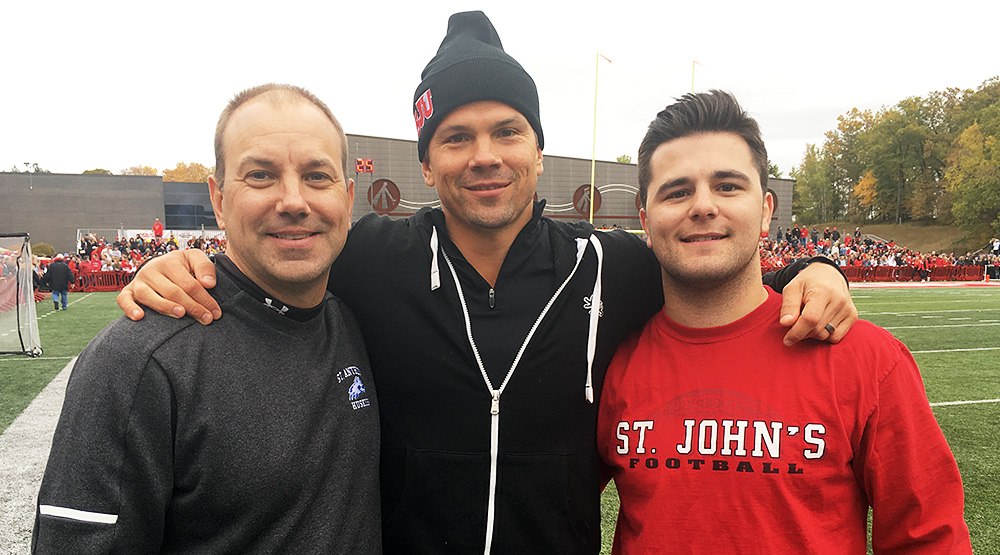 Chris Palmer, Blake Elliott and Carter Hanson pose on the sidelines at the 2018 Johnnie-Tommie game. (Photo by Frank Rajkowski)